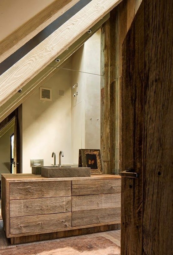 a wabi-sabi bathroom with rough wooden furniture, a stone sink and a vintage arwork looks impressive