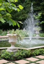 a fun and refreshing fountain right in the middle of a decorative pond is a fun and cool idea for pets and kids