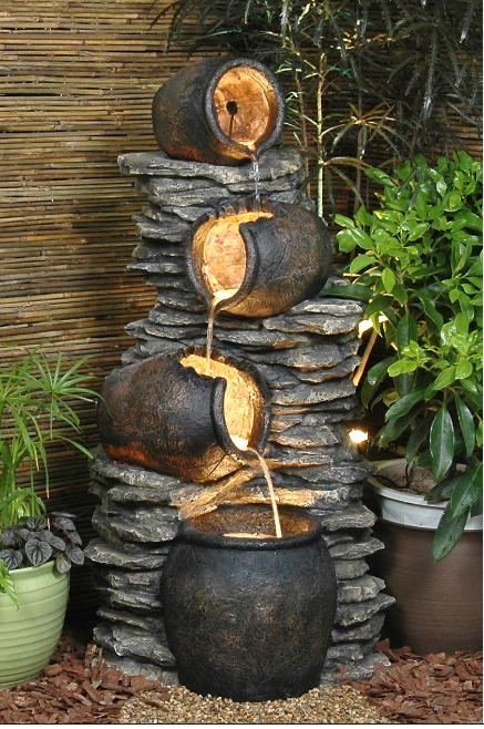 A cool and unusual fountain of stone and vessels that look like planters is a lovely idea for a fairy tale styled garden