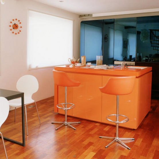 Bright orange cabinetry would be a "happy" addition to any modern kitchen.