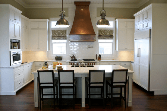 By combining several kitchen cabinets with two dining tables you can build a really functional kitchen island.