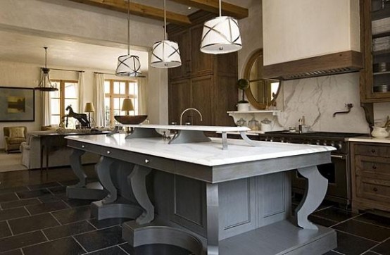 Large gorgeous kitchen island with gray wood support and white marble countertop. It's perfect for dining thanks to its size and an additional shelf in the middle where you could put plates with main dishes.