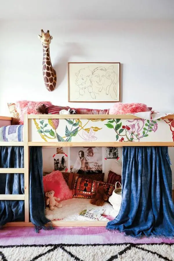 kura bed covered with scraps of floral wallpaper and with a cozy reading nook on the floor
