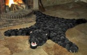 a faux animal skin fully made of black pompoms is a fun and eco-friendly way to incorporate animal items into decor