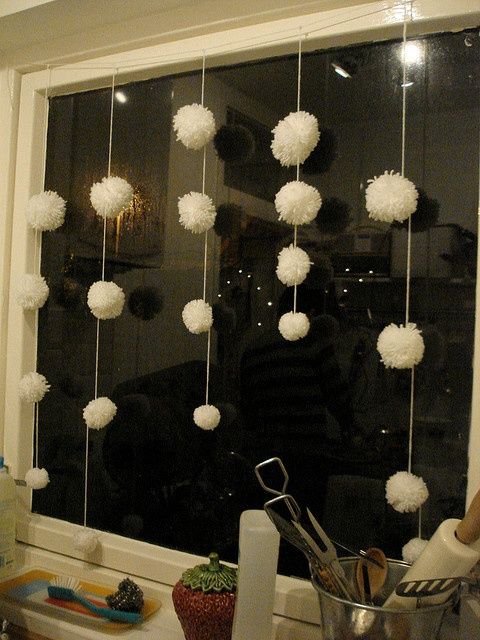 White pompom garlands like these ones will make your windows look veyr wintry like and very cozy