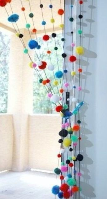 Colorful pompom curtains to divide the balcony from the rest of the interior   it's an easy way to do that and you can DIY that