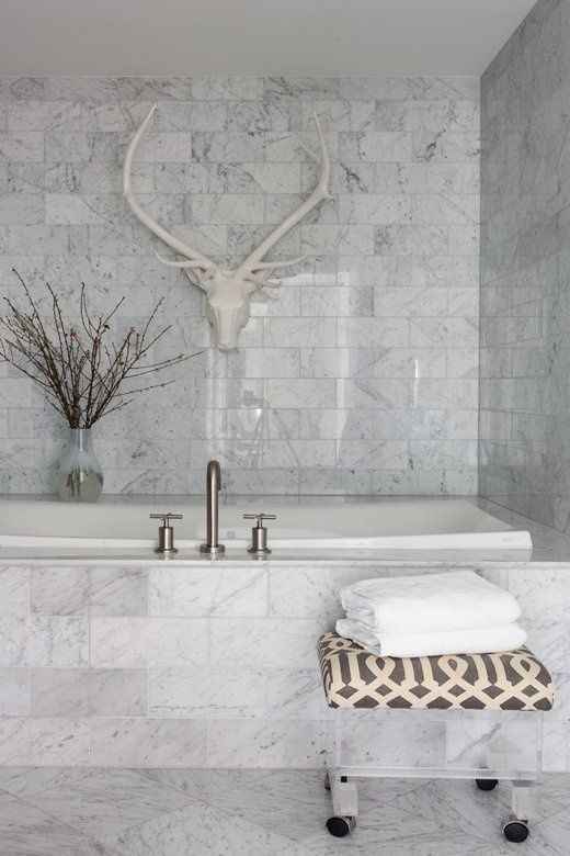 a white marble bathroom done with tiles - an amazing idea to use if you arne't ready to splurge on real marble