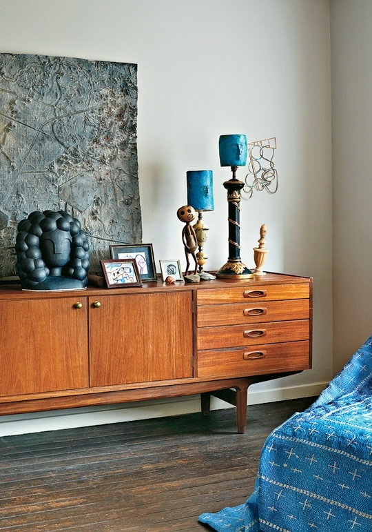 a rich-stained mid-century modern credenza with whimsical decor - candles, artwork and a couple of photos is a lovely idea