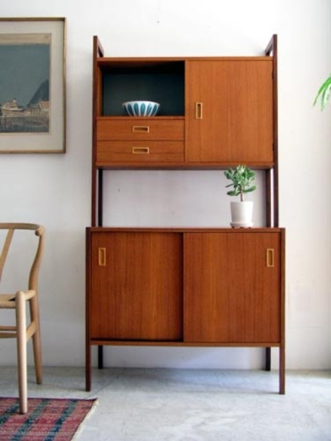 A large rich stained mid century modern cabinet with two parts and tall legs will save a lot of space letting you store a lot of things at the same time