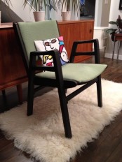 a comfy and stylish mid-century modern chair with a dark stained frame and legs and green upholstery is a cool idea