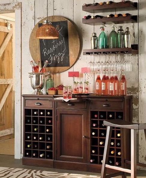 A dark stained vintage inspired wooden bar and some matching open shelves over it plus a chalkboard sign