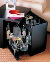 a black side table with a built-in home bar inside is a very smart idea to save some space in your home