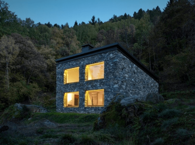 Minimalist cabin covered with stone from ruins  17