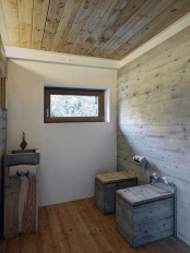 minimalist-cabin-covered-with-stone-from-ruins-7