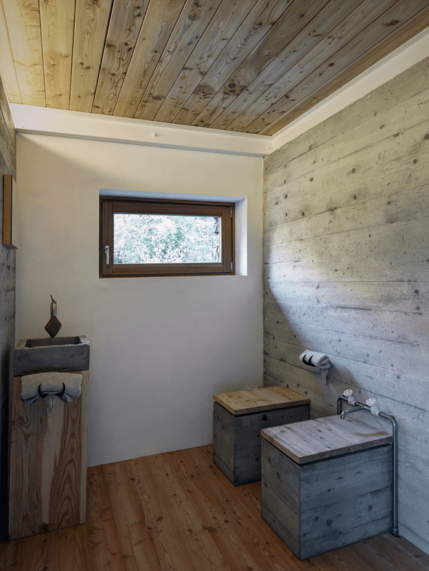 Minimalist cabin covered with stone from ruins  7
