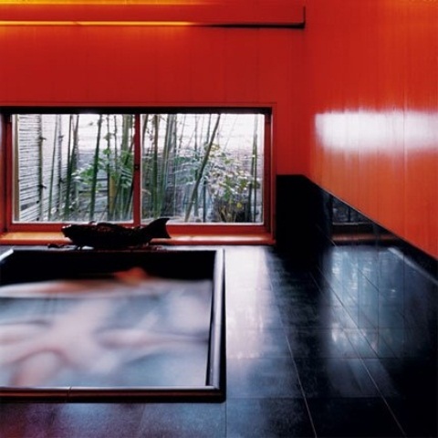 a bright orange and black meditation space with a bathing space