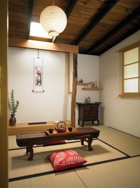 an Asian-style tea and meditation room with Asian furniture, rugs and pillows