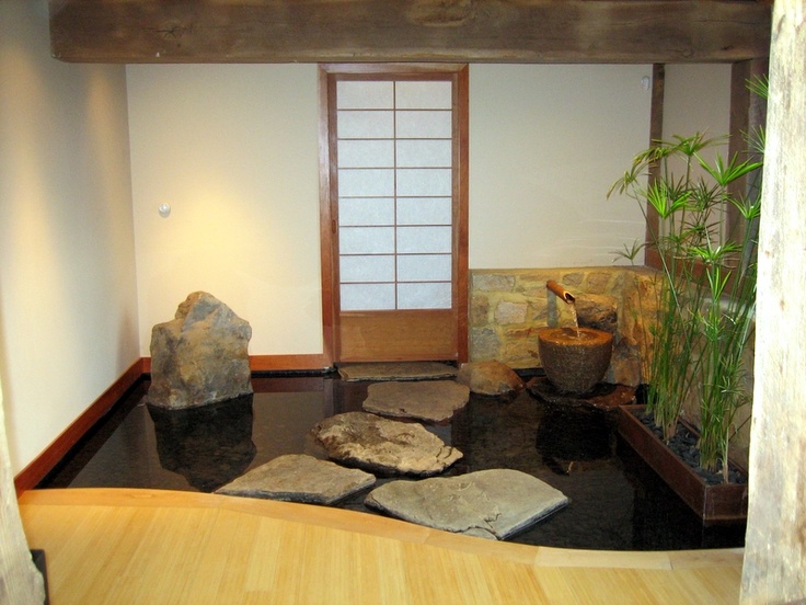 a meditation space with an inner pond, rocks, potted greenery for more relaxation