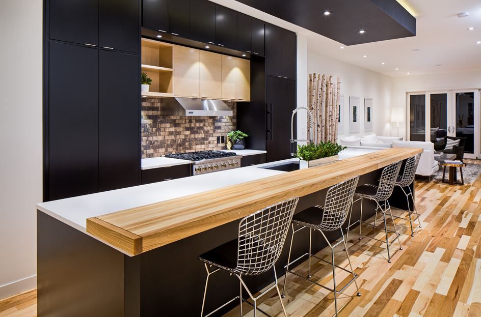 A good looking black kitchen with an island