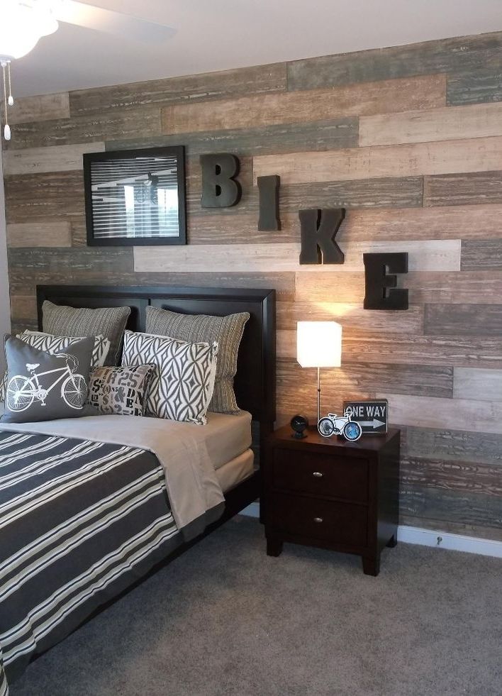 A shabby wood accent wall is a great way to spice things up in a teenage boy's room.