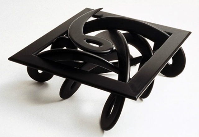 A black swirl coffee table will add a whimsy touch to the space and will make it look quirky and bold