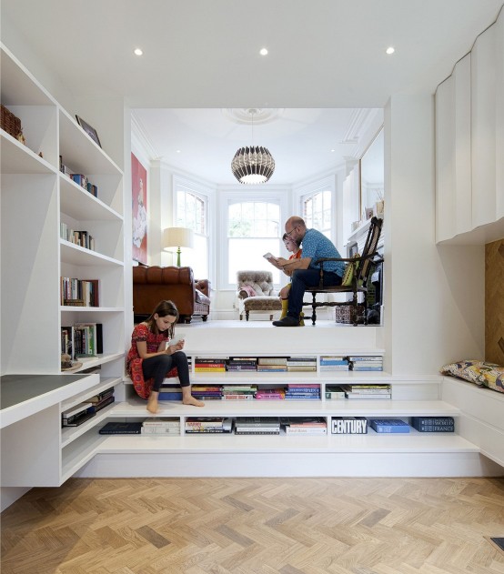 bookshelves built into the staircase is a very cool and space-saving idea for a modern home