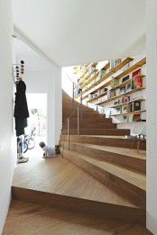 neutral floating bookshelves on the wall over the staircase won’t take some spearate space and you can read sitting on the steps
