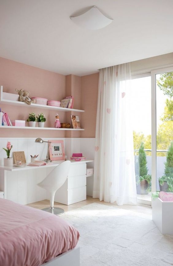 a romantic dusty, blush pink and white bedroom with pink bedding, heart printed curtains and simple white furniture