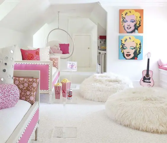 a cute and playful white and pink teen girl bedroom with modern furniture, a gallery wall and faux fur beanbag chairs