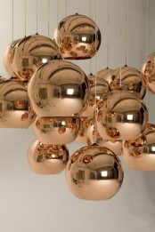 beautiful copper sphere pendant lamps hanging in a cluster are amazing for a modern or contemporary space, they add chic and a soft touch of color