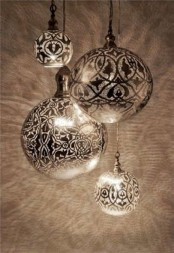 a cluster of spheric Moroccan pendant lamps will make your space more boho and mysterious, with shades on the walls