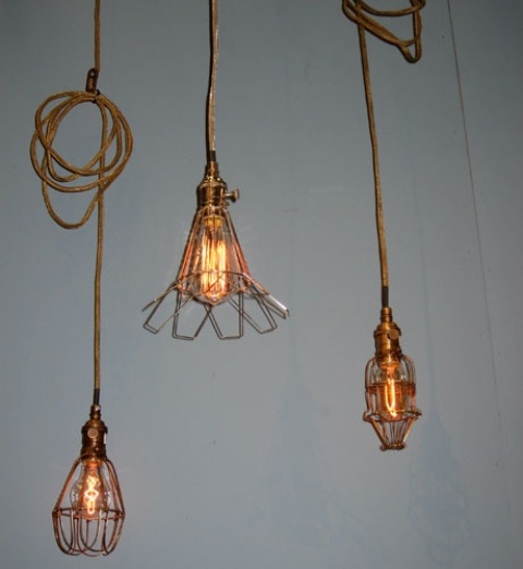 an arrangement of creative metal lampshade lamps on rope is a cool solution for an industrial space
