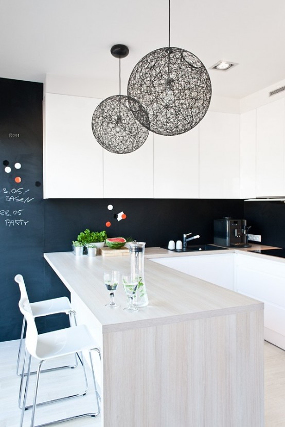 black woven spheric pendant lamps perfectly match this modern kitchen, black adds drama to the space