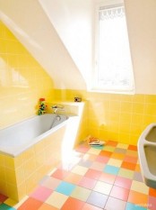 a yellow and white bathroom with a colorful tile floor is a fun idea to raise your mood and is a creative and bold space
