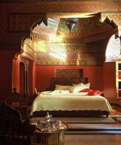 a unique bright patterned alcove is a perfect base for a Moroccan bedroom, carved wooden furniture and lanterns add to the space