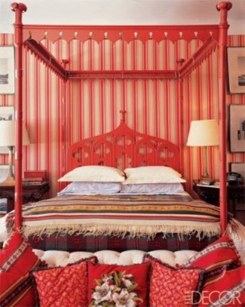 a bright red carved bed adds a Moroccan feel to the colorful bedroom