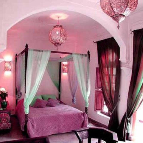 this Moroccan bedroom is given a girlish feel with shades of pink and fuchsia, with bright curtains and a canopy