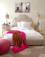 a pink Moroccan pouf, a printed rug and a catchy bed add a Moroccan feel to the sleeping space