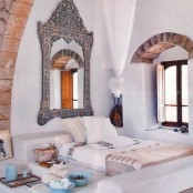 a statement ornate mirror and bedding inspried by Moroccan wedidng blankets look very chic and catchy
