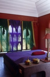 red combined with green and purple, a chic lamp and a catchy window with frames