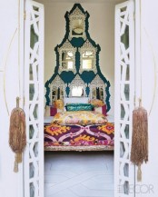 a unique wall decoration made of ornate mirrors, colorful bedding and tassels for a bright Eastern bedroom