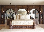 carved wooden panels, a bed and nightstands and Moroccan lanterns for a neutral Eastern room