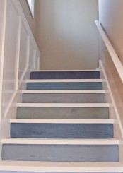 a nautical staircase with backing of steps done in various shades of blue and grey is a lovely and pretty idea