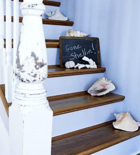 a shabby chic beach staircase with stained steps, seashells and a chalkboard sign plus shabbychic railing