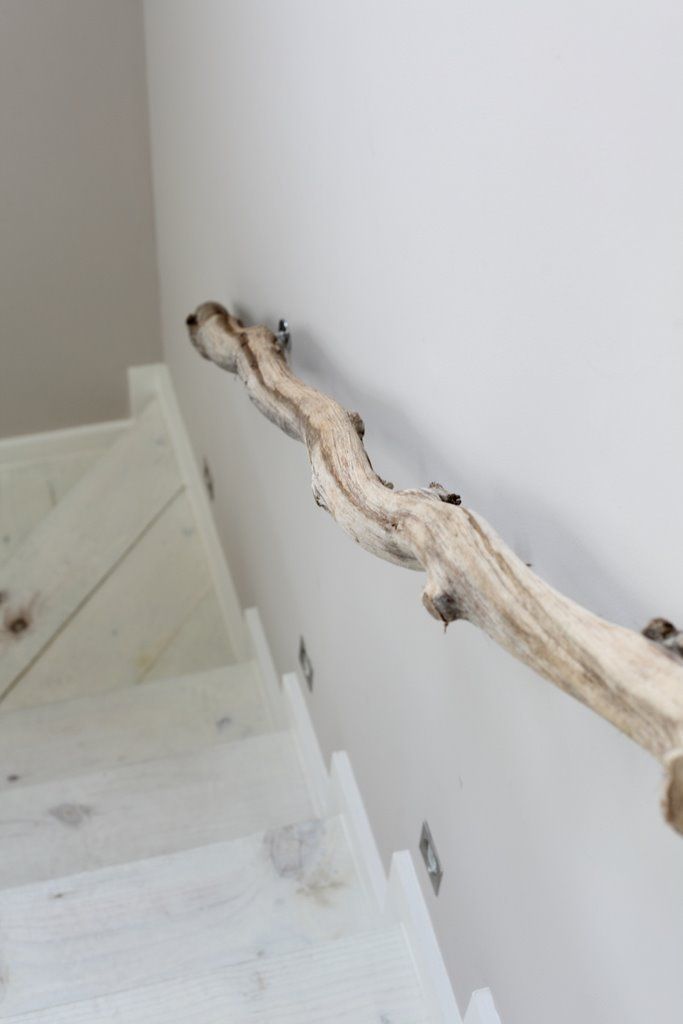 A whitewashed staircase with driftwood railings is a fresh and non typical idea of a beach staircase