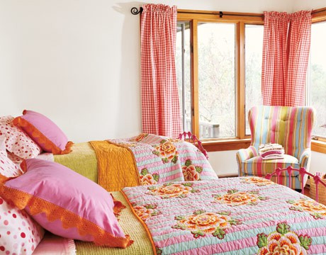 A shared neutral bedroom turned into a super bright one using bold textiles   curtains, pillows and blankets looks amazing