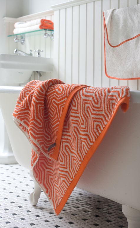 add bright orange touches to your neutral bathroom easily and without fuss with textiles - curtains, rugs and towels