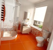 an orange floor with large scale tiles and white and orange flower tiles plus orange towels for a bright modern bathroom