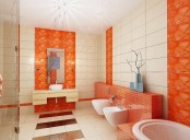 orange accents integrated into the bathroom decor with bright orange tiles in the sink, toilet and bathtub zone