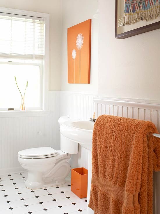 Add bright orange touches with an artwork, a litter box and some towels   it's easy to spruce up a neutral space with just some items